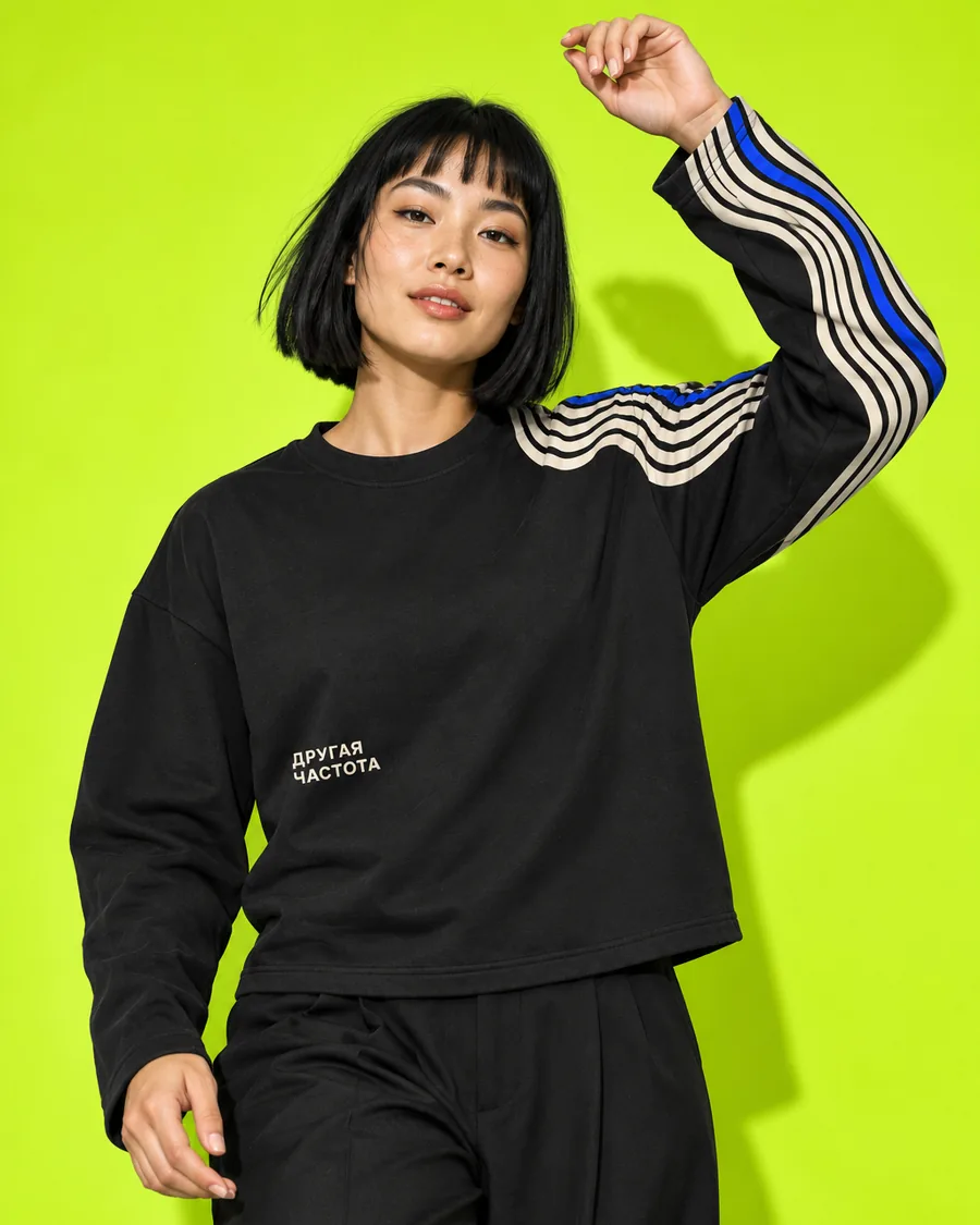 Black long-sleeve top with a striped print on the shoulder and sleeve, lime background