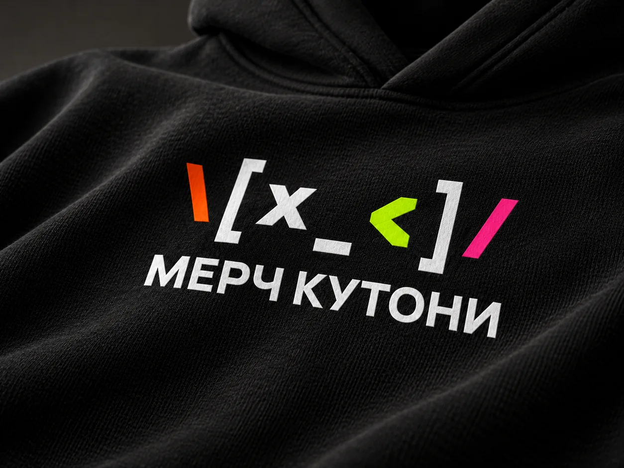 Macro: three-colour printed MERCH KUTONI mark on a black hoodie