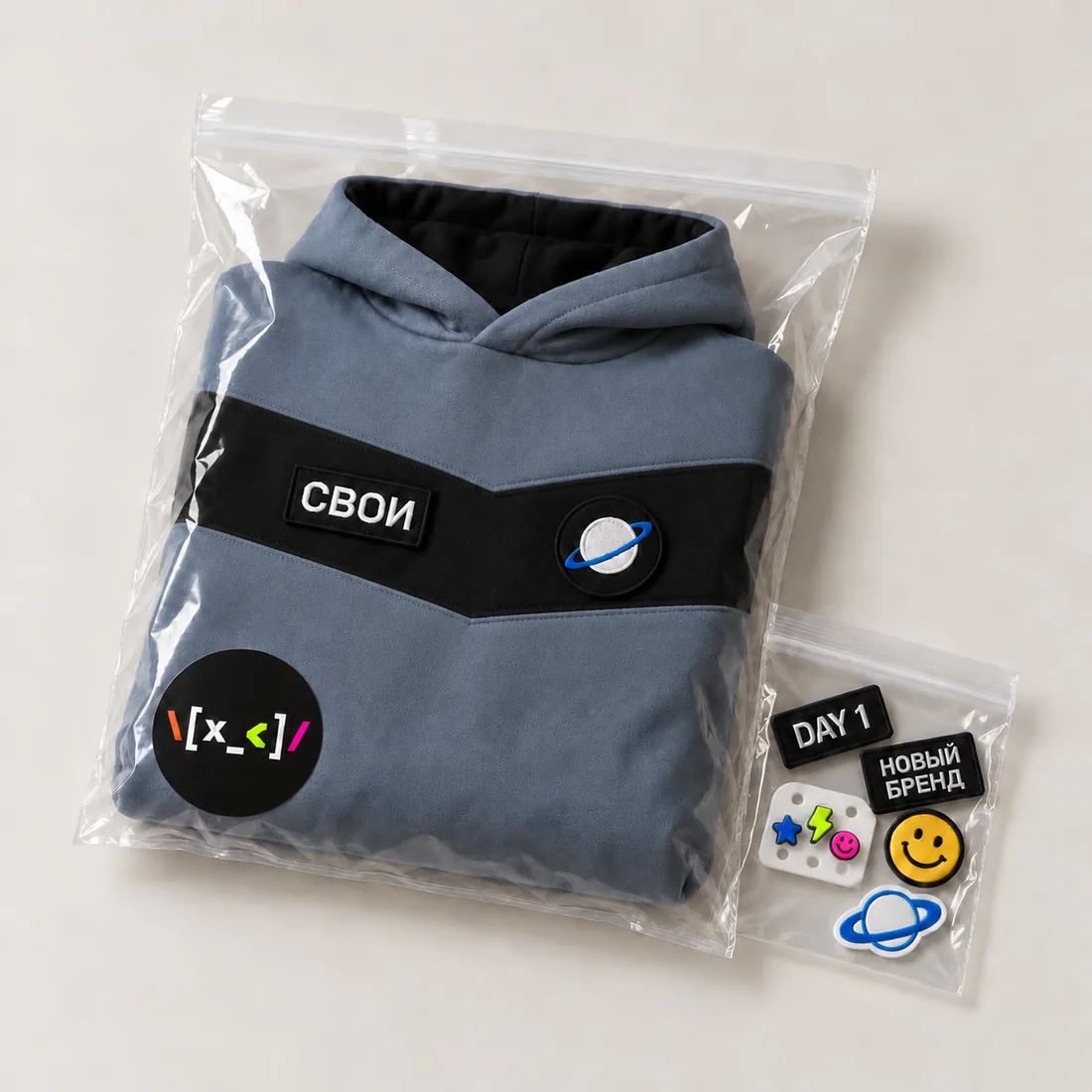 Sample before the run: a hoodie in a bag with a sticker and a small bag of swappable elements